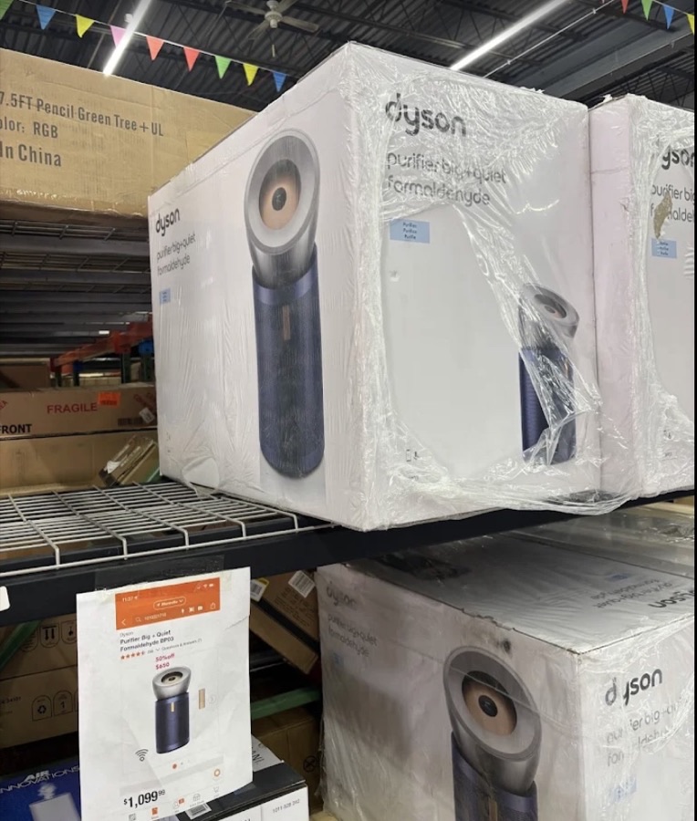 Stack of Dyson vacuums and small kitchen appliances at ABC Home Outlet