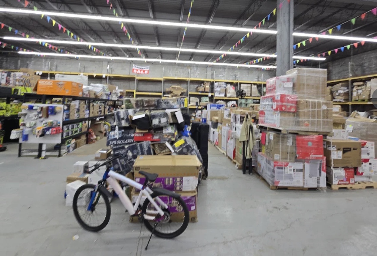 ABC Home Outlet store aisle with merchandise on pallets