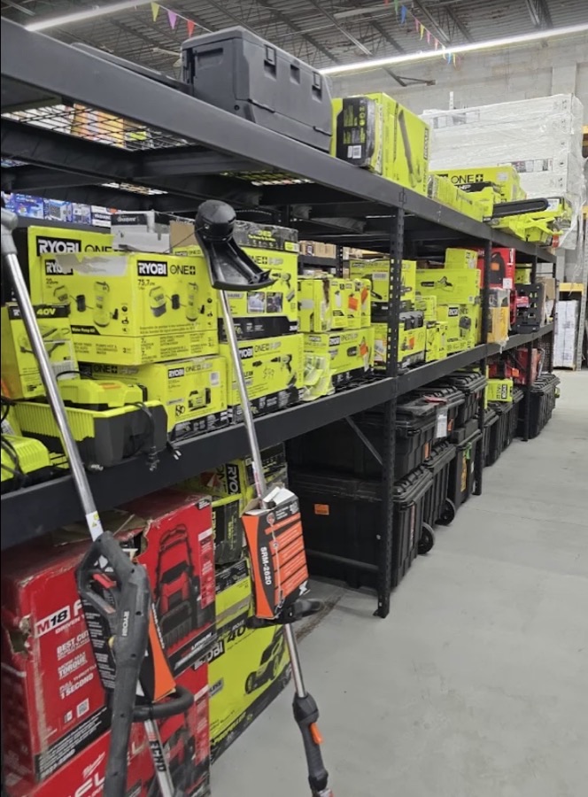 Shelves of Ryobi power tools and lawn equipment at ABC Home Outlet
